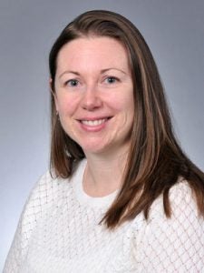 An image of Dr. Johanna Hannan. She has long brown hair and is smiling.